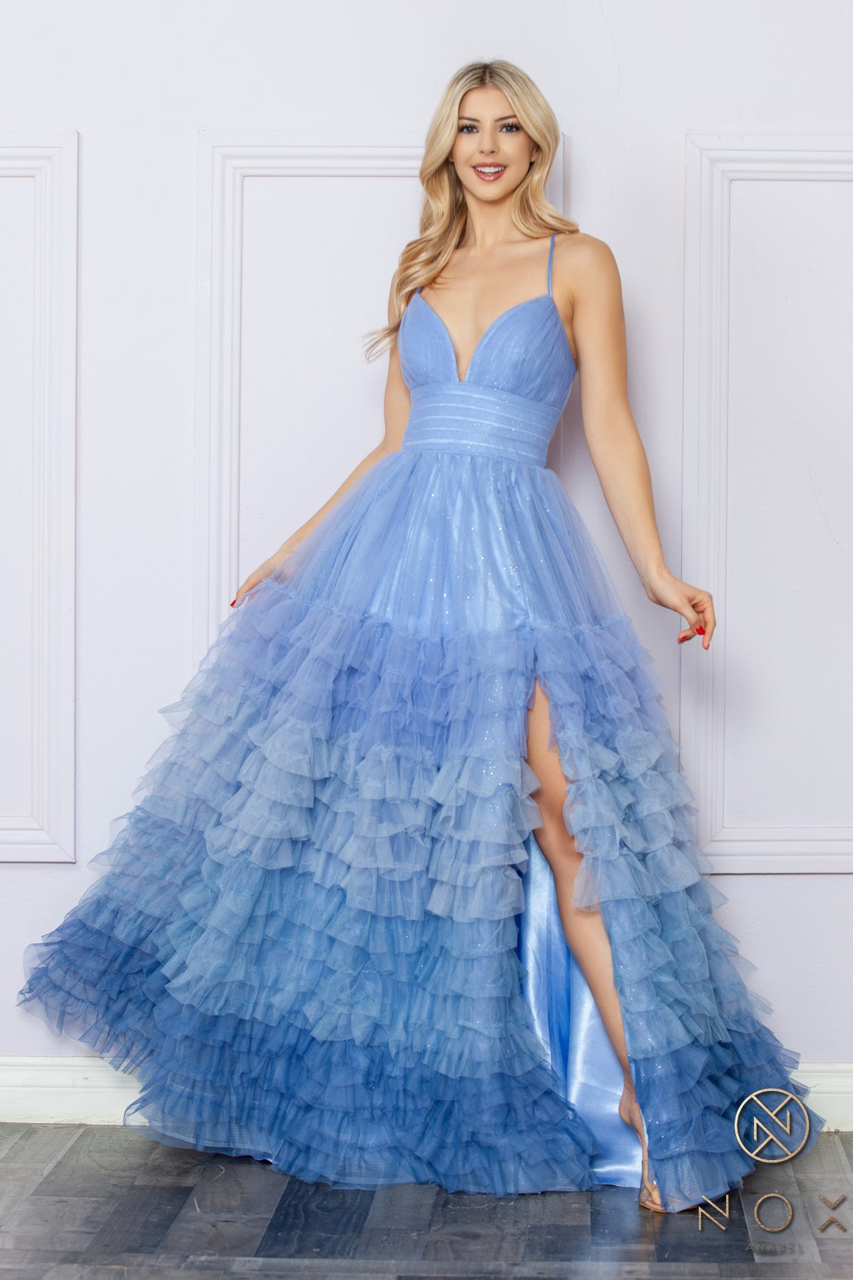 Elevate your formal look with the Nox Anabel C1420 A Line Ombre Maxi Dress. Made with layered tulle and a backless corset, this dress is both elegant and daring. Its A line silhouette features a leg slit, perfect for showcasing your beautiful legs. Make a statement at prom or any formal event.  Sizes: 0-16  Colors: Blush Ombre, Light Blue Ombre, Periwinkle Ombre, Purple Ombre