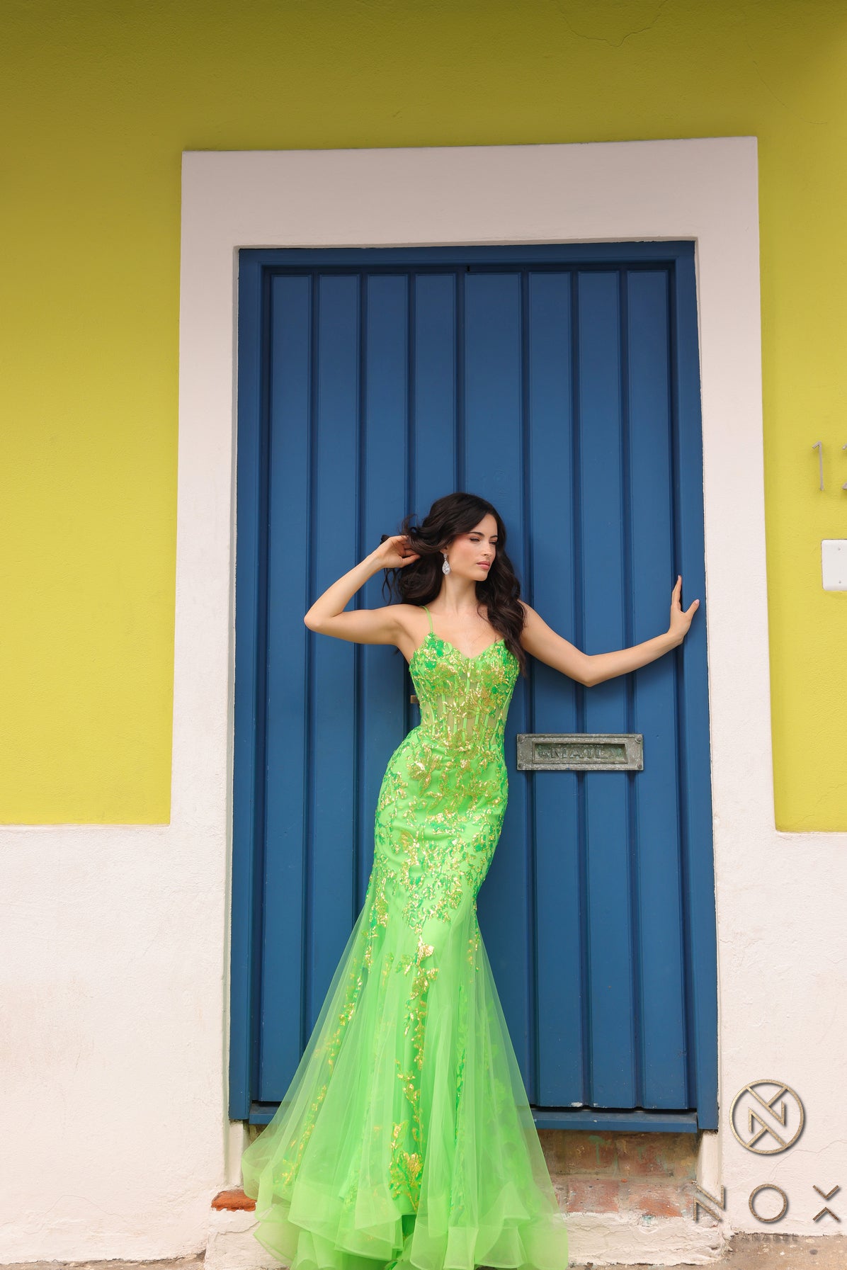 Elevate your prom or pageant look with the Nox Anabel Q1390 Prom Dress. Featuring a long sequin body with a sheer corset and mermaid silhouette, this dress will have you shining all night. Stand out in vibrant neon while feeling confident and elegant.  Sizes: 0-16  Colors: Neon Green, Neon Orange, Coral Fuchsia, Ocean Blue