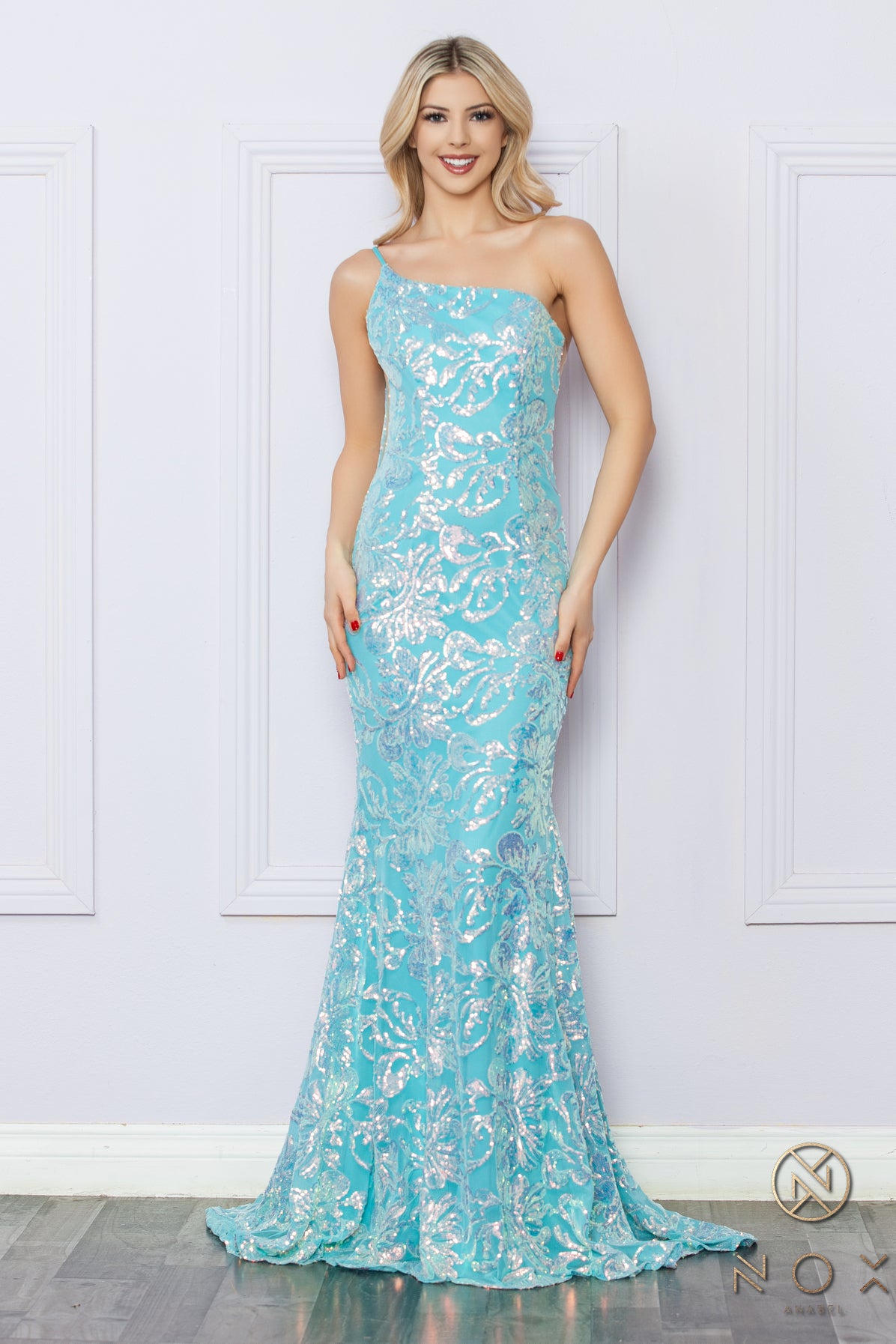 Be the ultimate showstopper in this stunning Nox Anabel R1308 sequin lace one shoulder prom dress. The mermaid silhouette and formal design will give you the confidence to shine on any pageant stage. Guaranteed to make a lasting impression, this gown is a must-have for any special occasion.  Size: 0-16  Colors: Fuchsia, Aqua Blue, White Multi