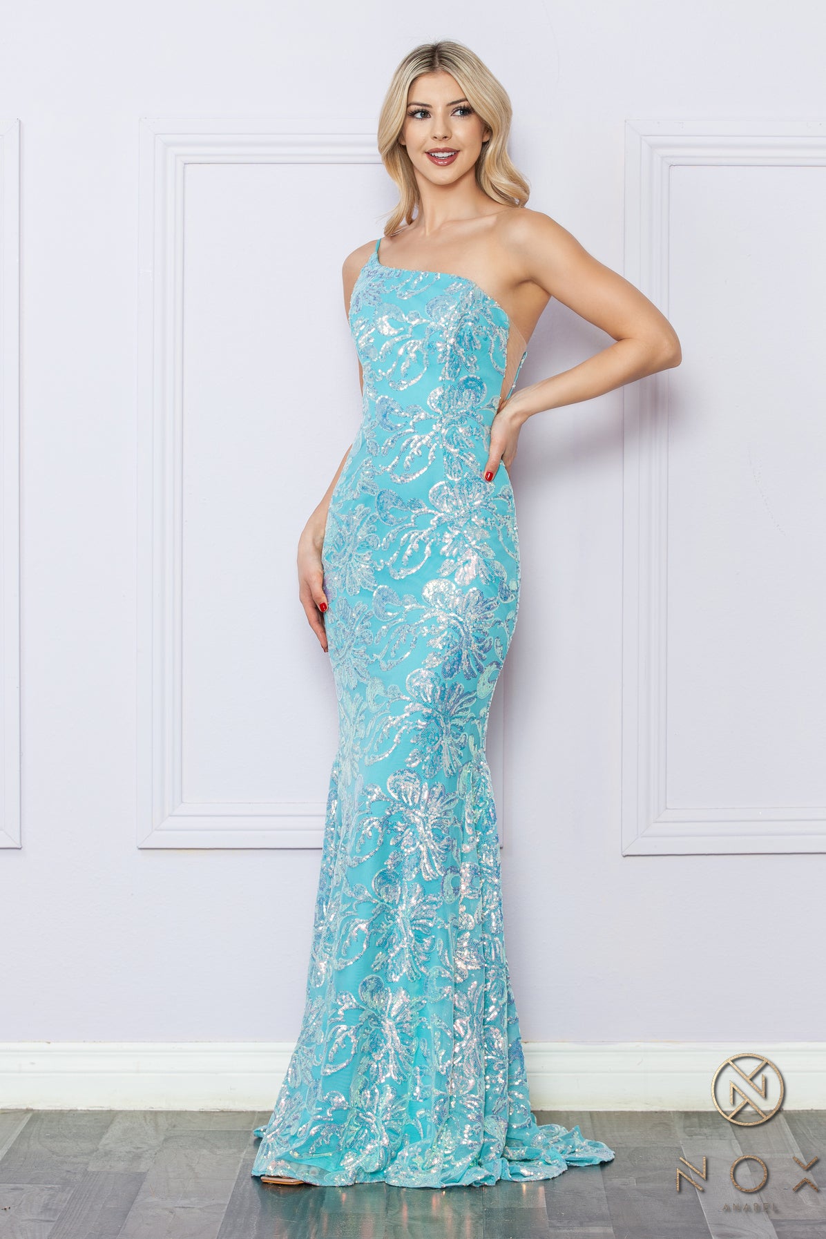 Be the ultimate showstopper in this stunning Nox Anabel R1308 sequin lace one shoulder prom dress. The mermaid silhouette and formal design will give you the confidence to shine on any pageant stage. Guaranteed to make a lasting impression, this gown is a must-have for any special occasion.  Size: 0-16  Colors: Fuchsia, Aqua Blue, White Multi