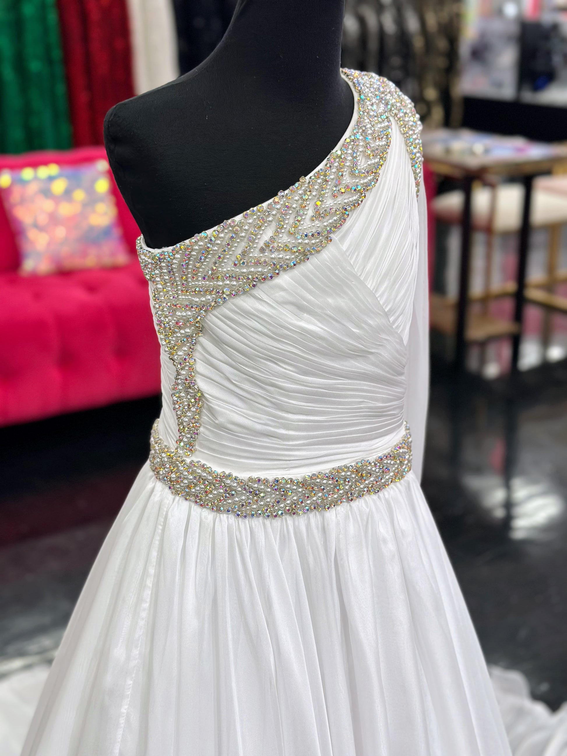 Be the epitome of grace and elegance in the Samanatha Blake 1014one shoulder Long Sleeve Pageant Dress. Made with delicate chiffon and a stunning crystal embellished bodice, this dress features a one-shoulder design and long sleeves for a sophisticated look. Perfect for any pageant or formal event.