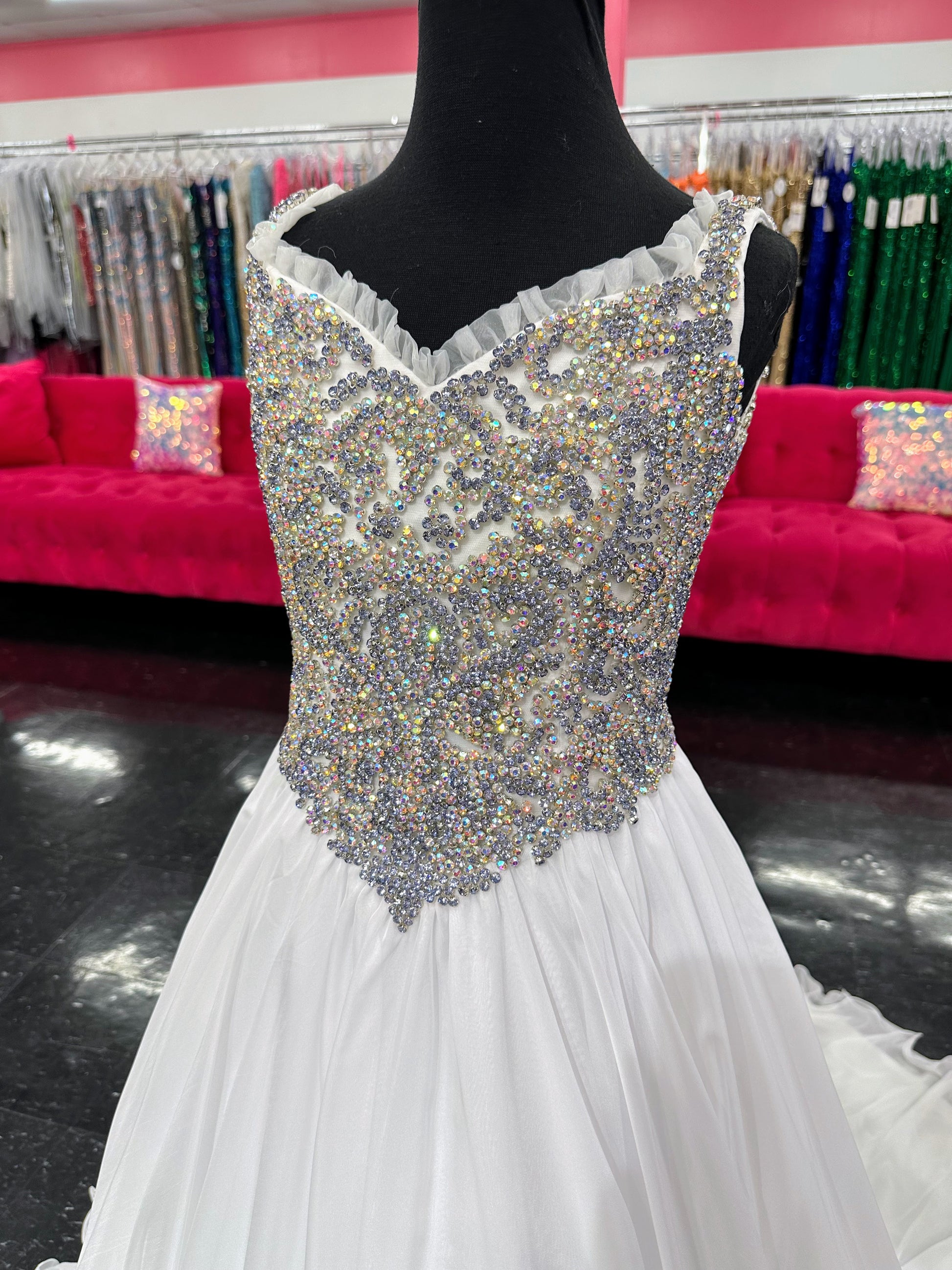 Experience the luxurious elegance of the Samantha Blake 1127 Pageant Dress. Made with soft, lightweight chiffon, this A-line ballgown will have your little girl feeling like a true princess. The crystal embellished bodice and ruffle trim neckline add a touch of sparkle and charm. Perfect for any pageant or special occasion.