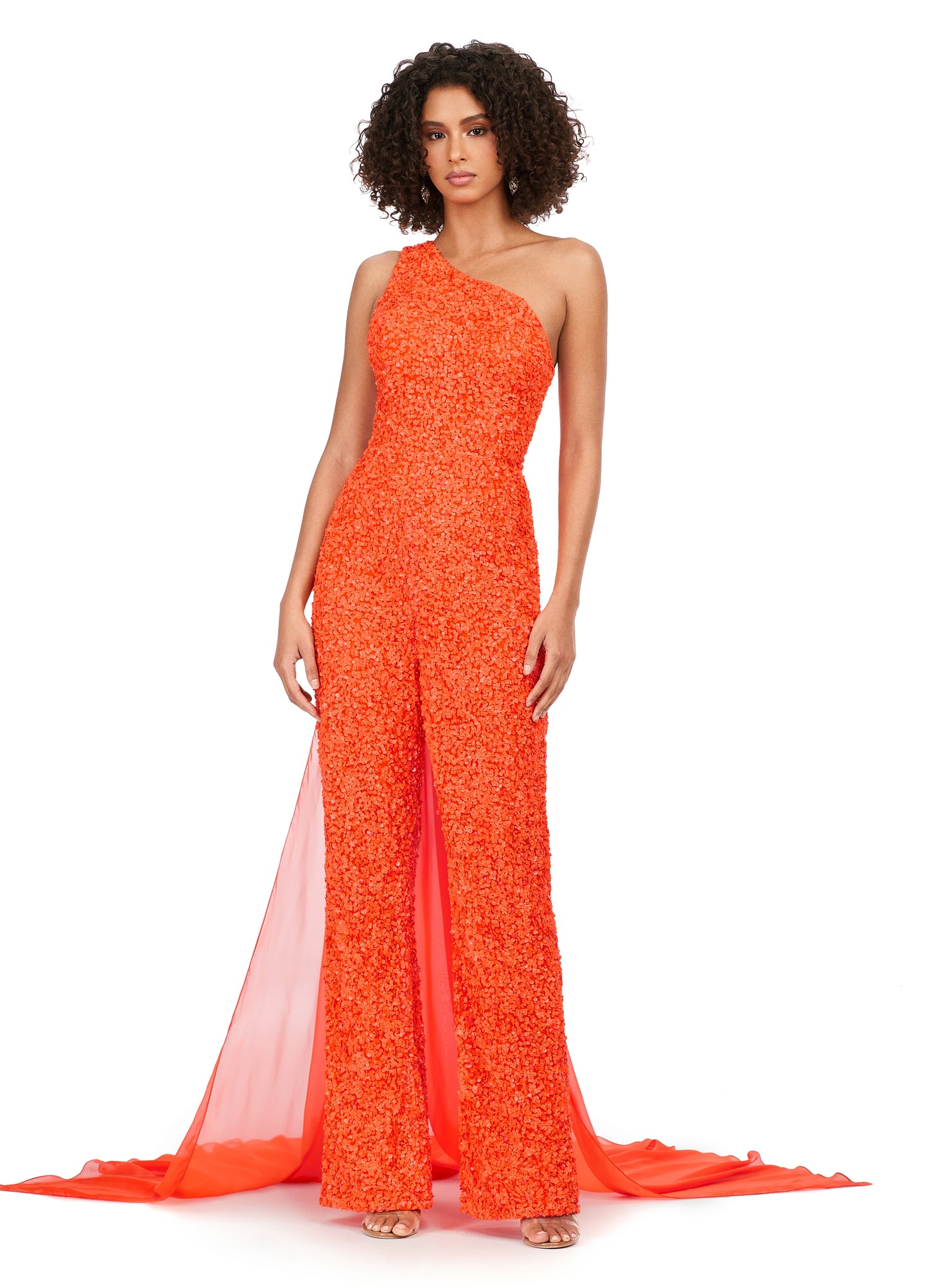 Ashley Lauren 11384 Fully Beaded With Removable Chiffon Cape One Shoulder Open Back Jumpsuit. Fall in love with this eye catching sequin jumpsuit! The one shoulder neckline is complete with a removable cape. The open back is adorned with sequin straps.