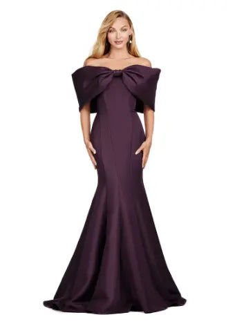 Experience elegance with the Ashley Lauren 11413 Long Prom Dress. Designed with an off-shoulder neckline, this dress is crafted from luxurious double-faced satin and features an oversized bow for added drama. Perfect for formal events and pageants, this dress will make you stand out with its sophisticated and flattering silhouette. Talk about elegant. This off shoulder gown is complete with an oversized bow along the neckline. This double faceted satin gown has a mermaid silhouette.