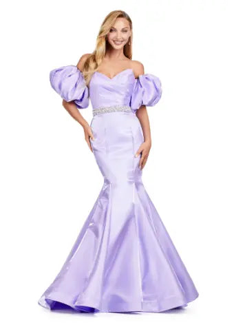 Expertly crafted by Ashley Lauren, this 11419 Long Prom Dress boasts a stunning mermaid silhouette with a strapless design and luxurious satin fabric. The oversized puff sleeves add a bold and elegant touch, making you stand out at any formal event or pageant. Elevate your look with this timeless and sophisticated gown.  Voluminous puff sleeves and a classic sweetheart neckline frame this stunning gown. With its mermaid fit and jeweled belt, this gown is a dream come true!