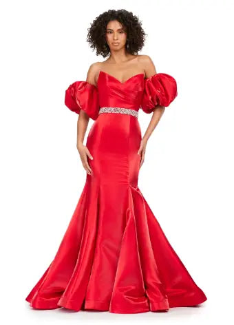 Expertly crafted by Ashley Lauren, this 11419 Long Prom Dress boasts a stunning mermaid silhouette with a strapless design and luxurious satin fabric. The oversized puff sleeves add a bold and elegant touch, making you stand out at any formal event or pageant. Elevate your look with this timeless and sophisticated gown.  Voluminous puff sleeves and a classic sweetheart neckline frame this stunning gown. With its mermaid fit and jeweled belt, this gown is a dream come true!