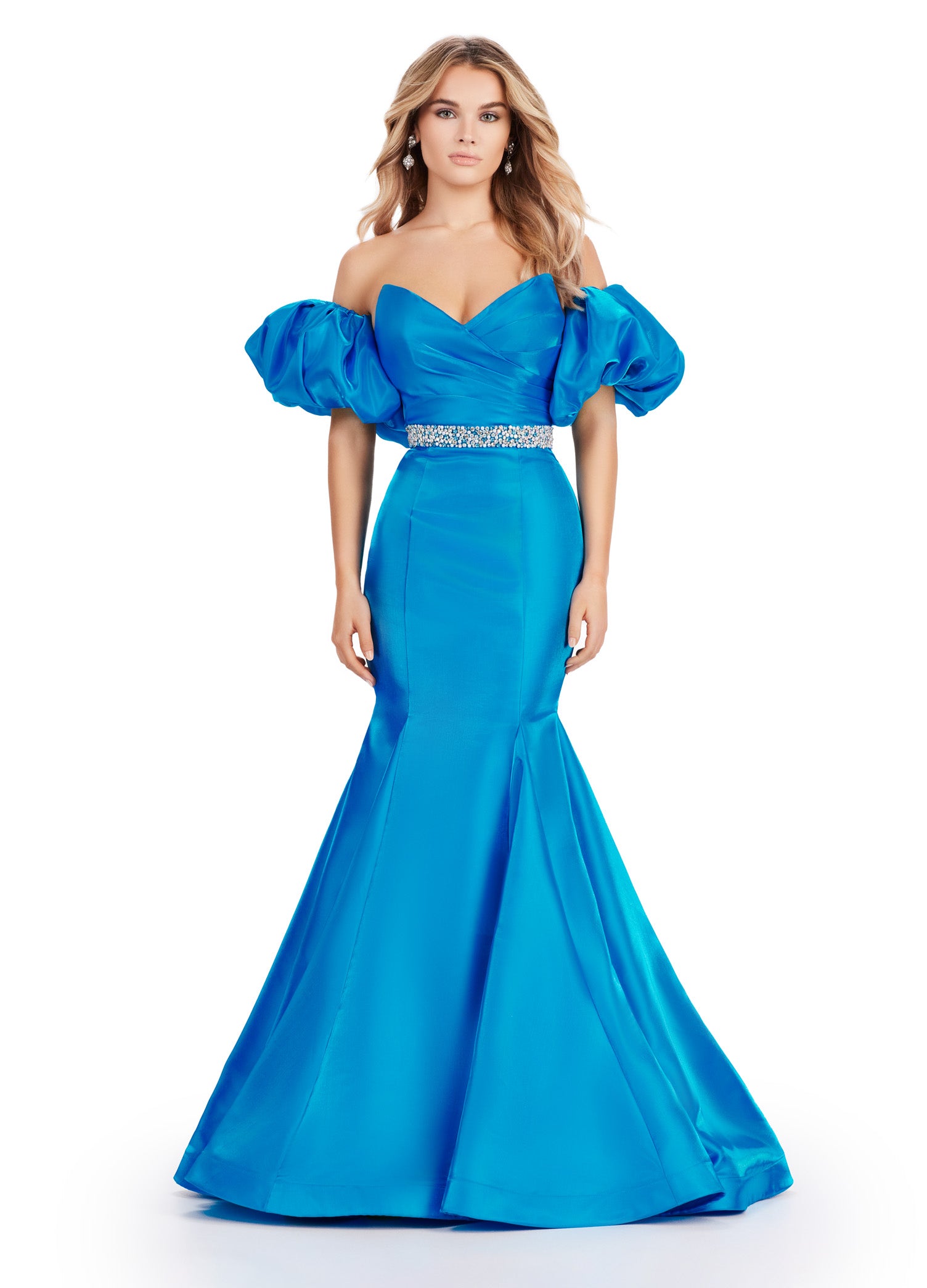 Expertly crafted by Ashley Lauren, this 11419 Long Prom Dress boasts a stunning mermaid silhouette with a strapless design and luxurious satin fabric. The oversized puff sleeves add a bold and elegant touch, making you stand out at any formal event or pageant. Elevate your look with this timeless and sophisticated gown.  Voluminous puff sleeves and a classic sweetheart neckline frame this stunning gown. With its mermaid fit and jeweled belt, this gown is a dream come true!