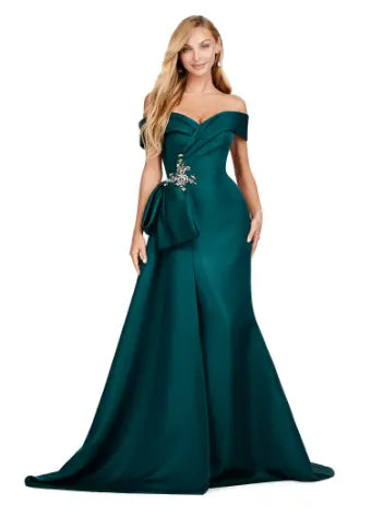 This Ashley Lauren 11425 Long Prom Dress is the perfect choice for any formal occasion. The off-shoulder design adds a touch of elegance, while the fitted satin fabric hugs your figure for a flattering silhouette. The overskirt adds a dramatic flare, making you feel like a pageant queen. Elevate your style with this versatile and stunning dress. An elegant off the shoulder neckline drapes the shoulders in elegant evening gown. The look is complete with beaded details and a side overskirt.