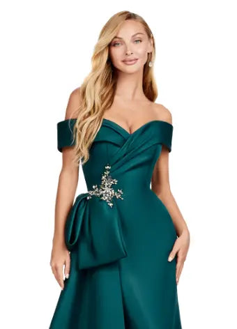 This Ashley Lauren 11425 Long Prom Dress is the perfect choice for any formal occasion. The off-shoulder design adds a touch of elegance, while the fitted satin fabric hugs your figure for a flattering silhouette. The overskirt adds a dramatic flare, making you feel like a pageant queen. Elevate your style with this versatile and stunning dress. An elegant off the shoulder neckline drapes the shoulders in elegant evening gown. The look is complete with beaded details and a side overskirt.