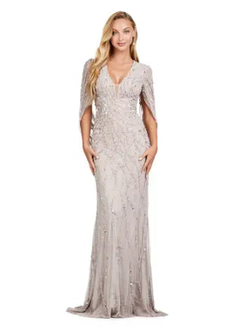 This long prom dress by Ashley Lauren 11430 features a stunning sequin V-neck and elegant cape sleeves, perfect for a formal pageant or evening event. The modern design and quality construction make it a must-have for any fashion-forward individual looking to make a statement. Look and feel confident in this unique, eye-catching gown. 