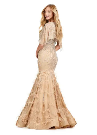 Make a statement in the Ashley Lauren 11431 Long Prom Mermaid Dress. This elegant gown features intricate beading and an asymmetrical cape, creating a stunning silhouette that will turn heads. Perfect for formal occasions and pageants, this dress will make you feel confident and glamorous. Classy with a twist. This fully beaded gown features a sheer asymmetric cape and feathers throughout the skirt.