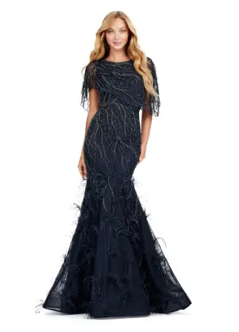 Make a statement in the Ashley Lauren 11431 Long Prom Mermaid Dress. This elegant gown features intricate beading and an asymmetrical cape, creating a stunning silhouette that will turn heads. Perfect for formal occasions and pageants, this dress will make you feel confident and glamorous. Classy with a twist. This fully beaded gown features a sheer asymmetric cape and feathers throughout the skirt.