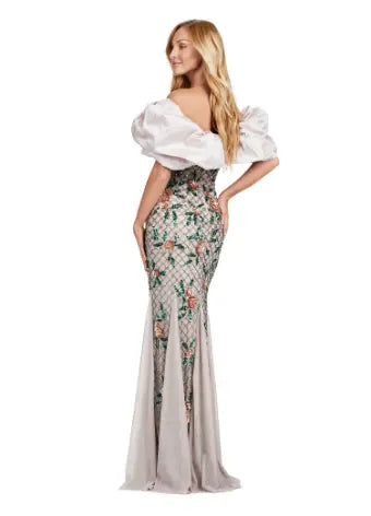 The Ashley Lauren 11433 long prom dress features a beaded off shoulder design and oversized ruffle detailing, making it the perfect formal pageant gown. Its elegant and figure-hugging silhouette is sure to make you stand out among the crowd. Channel your inner pageant queen and capture everyone's attention with this stunning dress. A fully beaded gown sure to steal the show. This gown features an oversized off shoulder taffeta ruffle taking this look to the next level.