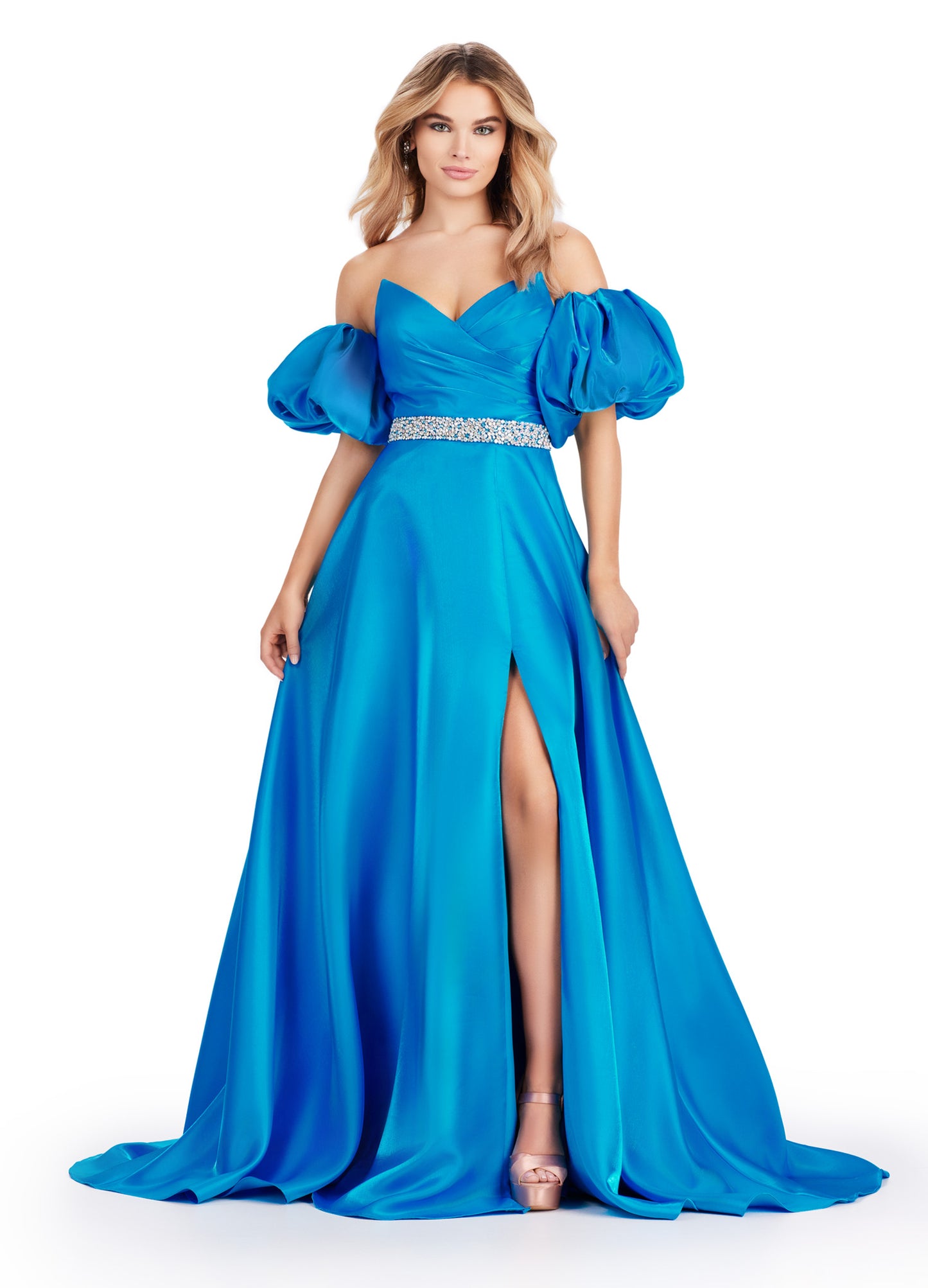 Elevate your formal look with the Ashley Lauren 11474 Long Prom Dress. This elegant strapless satin ball gown boasts a beaded belt, detachable puff sleeves, and a timeless pageant-style design. Perfect for making a statement at any event, this dress exudes sophistication and style. Be memorable in this strapless satin ball gown. This dress features a beaded belt detail, a left leg slit and detachable puff sleeves.