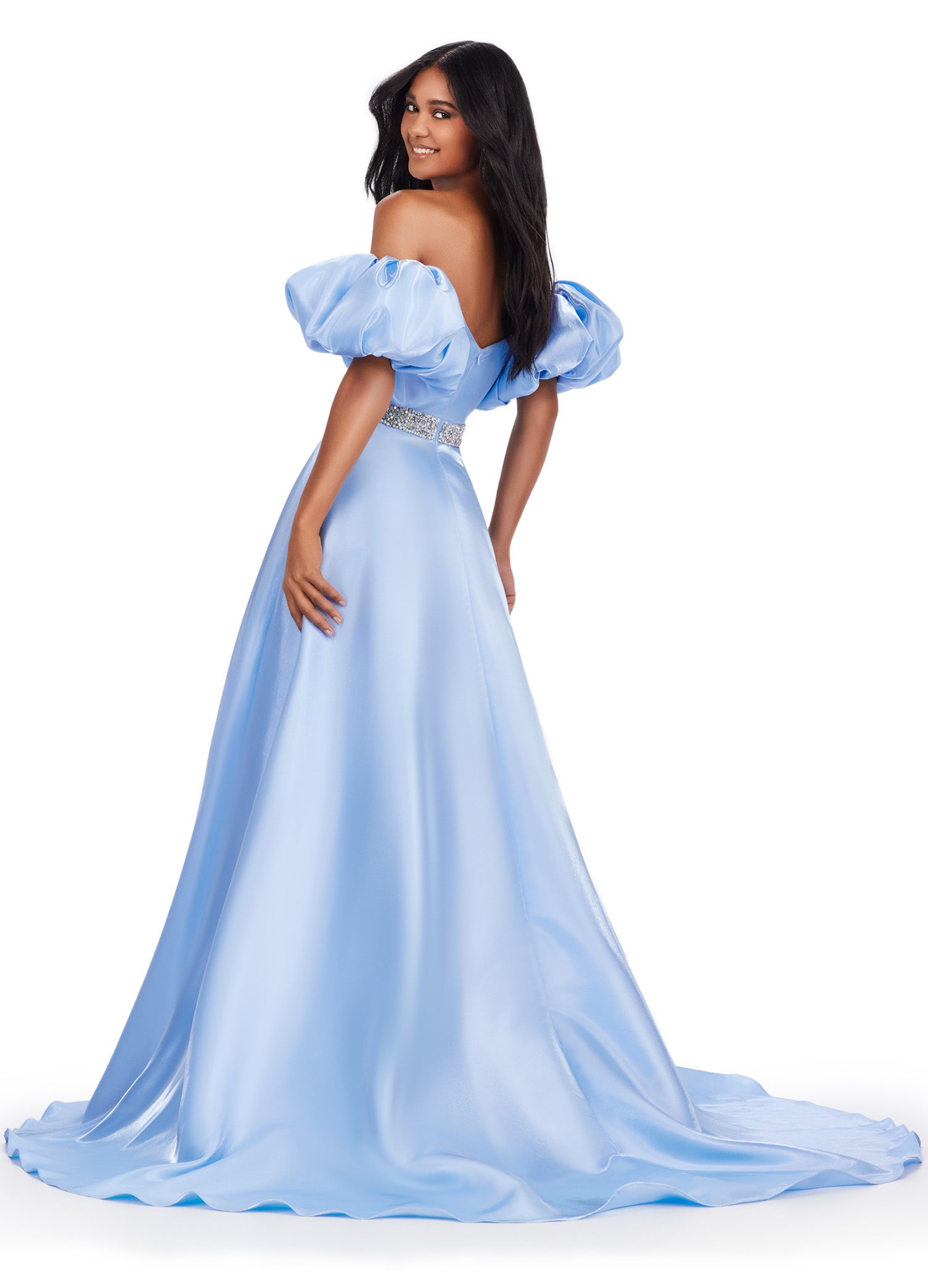 Elevate your formal look with the Ashley Lauren 11474 Long Prom Dress. This elegant strapless satin ball gown boasts a beaded belt, detachable puff sleeves, and a timeless pageant-style design. Perfect for making a statement at any event, this dress exudes sophistication and style. Be memorable in this strapless satin ball gown. This dress features a beaded belt detail, a left leg slit and detachable puff sleeves.