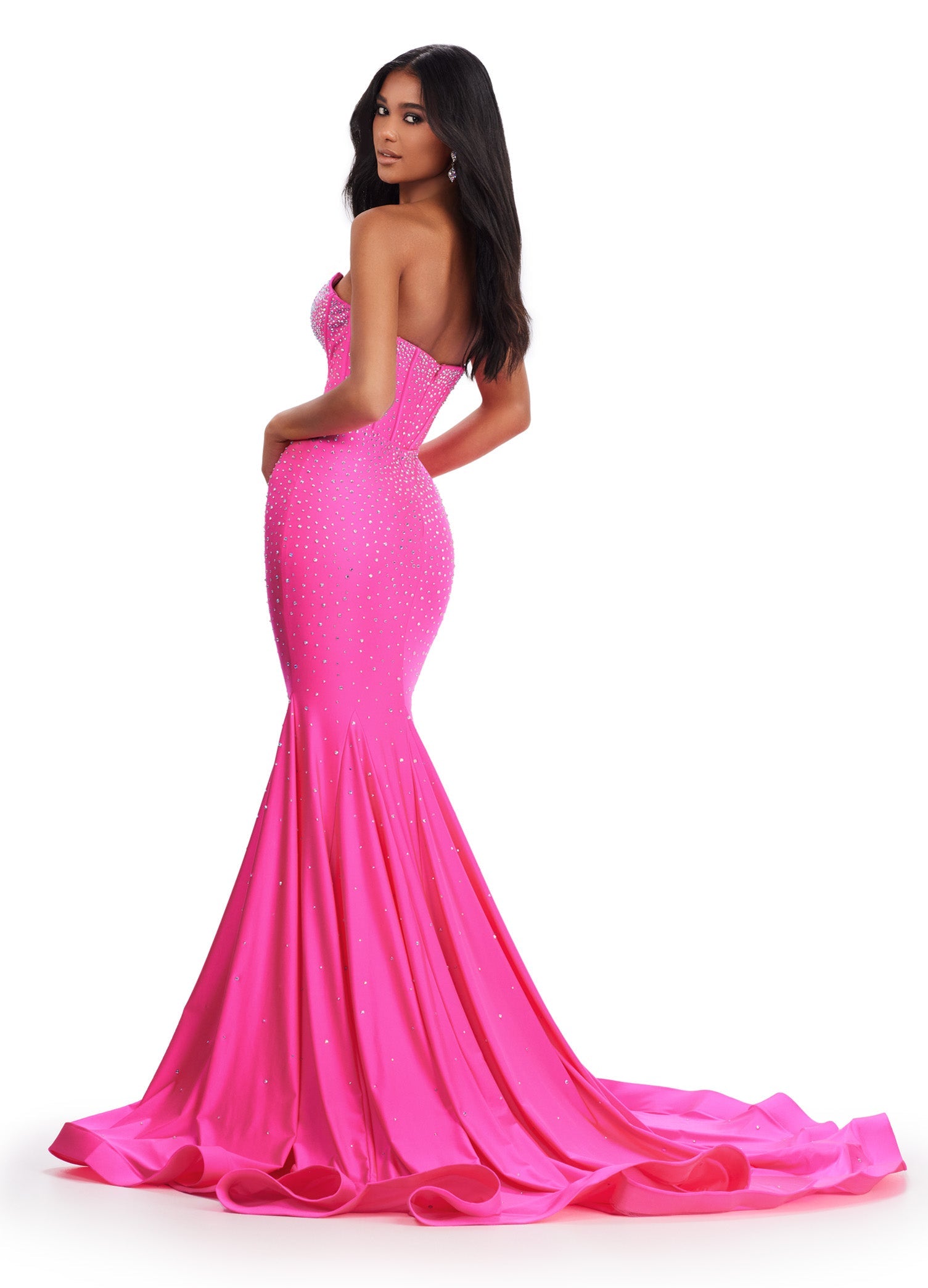 This elegant Ashley Lauren 11560 dress features a strapless neckline, fitted jersey fabric, and a mermaid silhouette that will accentuate your figure. The V-neck adds a touch of sophistication to this formal gown, making it perfect for prom or a pageant. Feel confident and beautiful in this stunning dress. This classic strapless jersey gown features a fully beaded corset bustier. The press on stones make this extra glamourous.