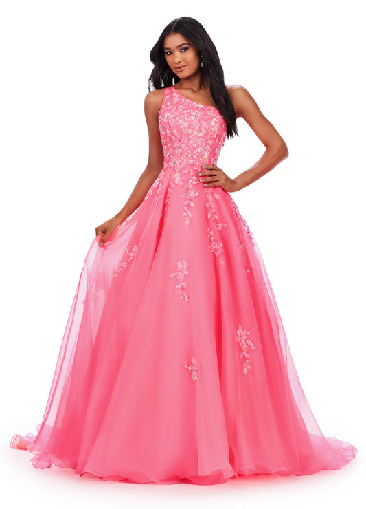 This Ashley Lauren 11573 Long Prom Dress exudes elegance with its one shoulder design and sequin applique. Crafted from high-quality organza, this gown will make you stand out at any formal event or pageant. Its classic silhouette and sparkling details are perfect for making a statement. This romantic one shoulder organza ball gown features intricate sequin applique. The look is complete with an open back and a one shoulder cape.