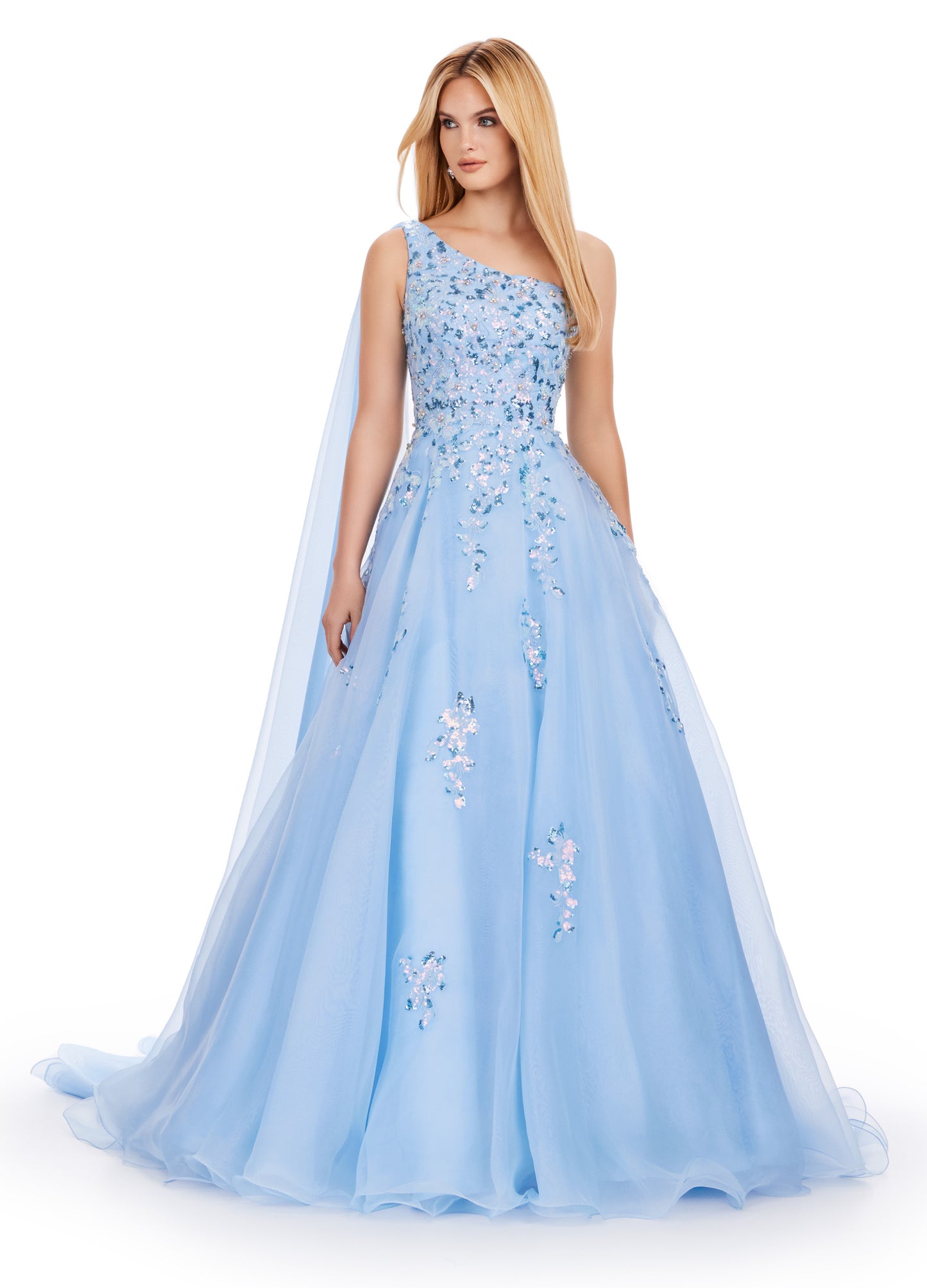 This Ashley Lauren 11573 Long Prom Dress exudes elegance with its one shoulder design and sequin applique. Crafted from high-quality organza, this gown will make you stand out at any formal event or pageant. Its classic silhouette and sparkling details are perfect for making a statement. This romantic one shoulder organza ball gown features intricate sequin applique. The look is complete with an open back and a one shoulder cape.