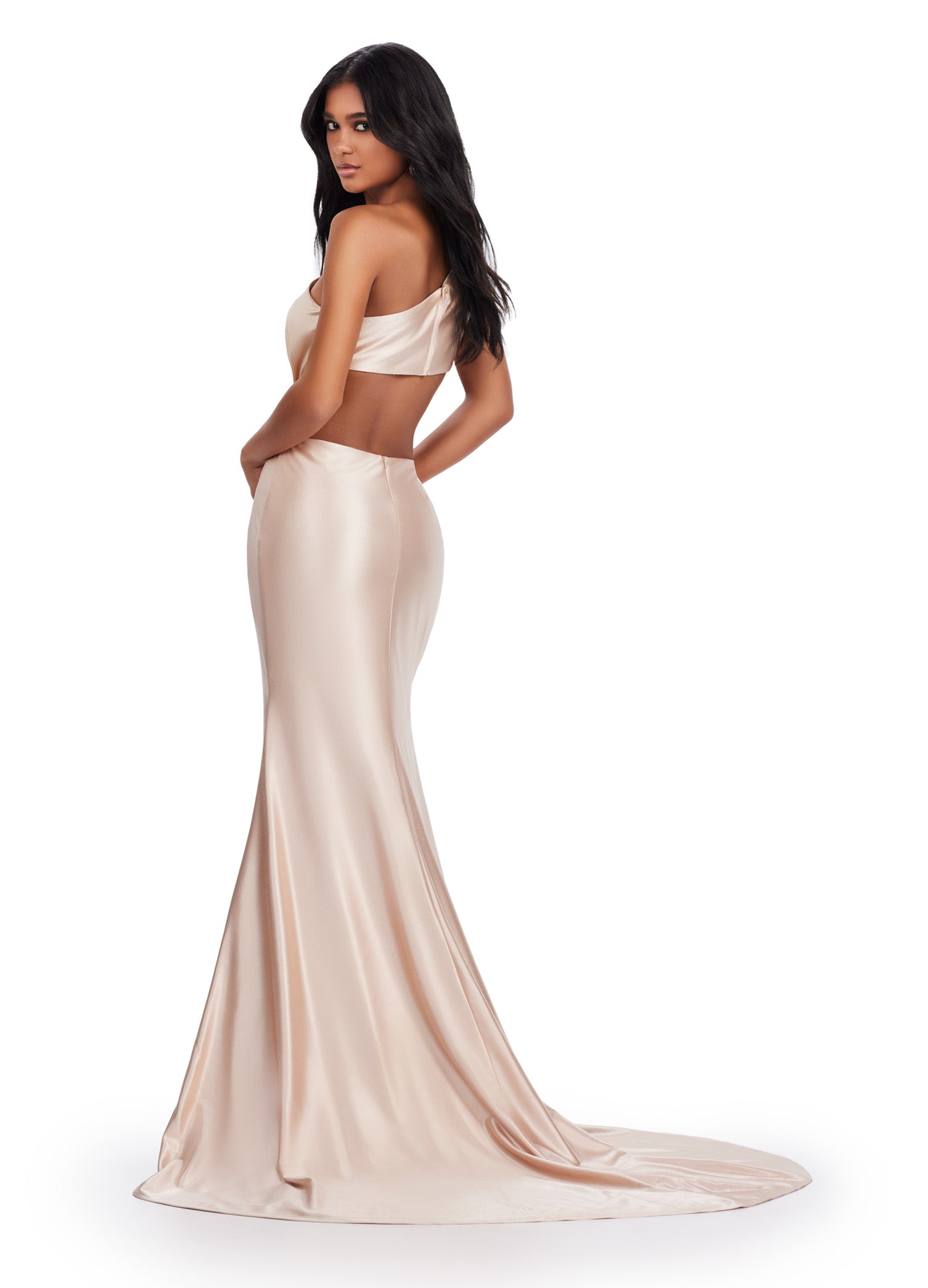 xpertly designed by Ashely Lauren, this elegant 11577 Long Prom Dress features a fitted one shoulder satin gown with stylish cut outs and intricate beading. Perfect for formal events and pageants, it offers a sophisticated and flattering silhouette for any occasion. Elevate your style with this stunning gown. This simplistic, yet elegant one shoulder satin gown features an elegantly draped bodice leading to a side cut out. The look is accented by a beaded brooch.