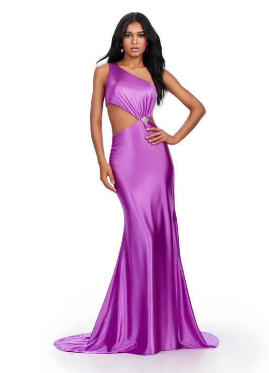 xpertly designed by Ashely Lauren, this elegant 11577 Long Prom Dress features a fitted one shoulder satin gown with stylish cut outs and intricate beading. Perfect for formal events and pageants, it offers a sophisticated and flattering silhouette for any occasion. Elevate your style with this stunning gown. This simplistic, yet elegant one shoulder satin gown features an elegantly draped bodice leading to a side cut out. The look is accented by a beaded brooch.