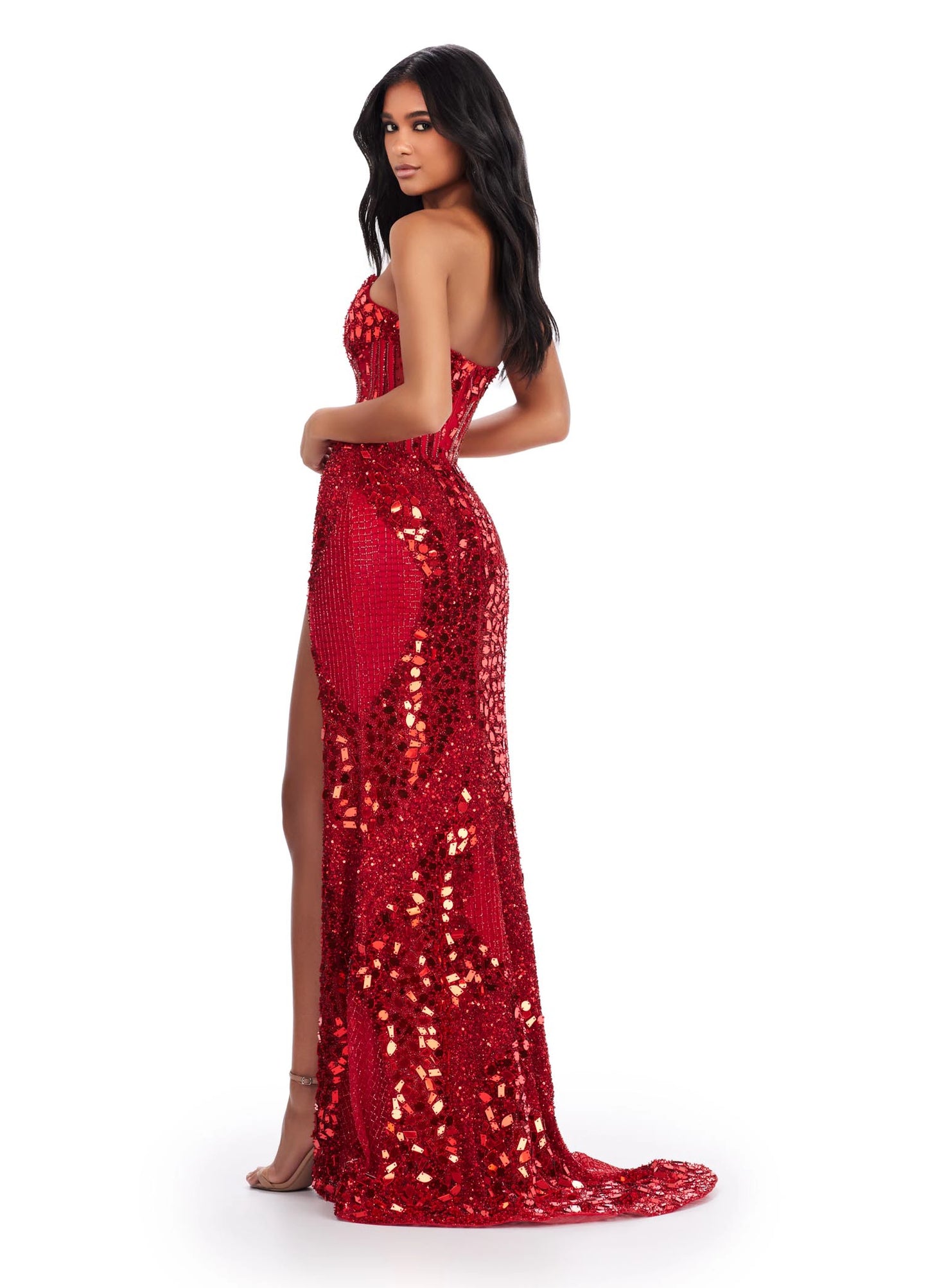 The Ashley Lauren 11599 prom dress is an eye-catching statement piece. Crafted from luxurious glistening cut glass fabric, this gown features an alluring corset-style bodice and a show-stopping thigh-high slit. The gleaming beaded embellishments add a touch of sparkle that is sure to make you shine