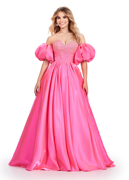 Elevate your formalwear with the Ashley Lauren 11642 prom dress. The luxurious satin fabric, sweetheart neckline, and crystal corset add elegance and charm to this A-line ballgown. The puff sleeves bring a touch of drama and playfulness to your look. Perfect for prom or pageants. A satin ball gown fit for a queen. This strapless dress features a beaded corset bodice with detachable puff sleeves and a lace up back.