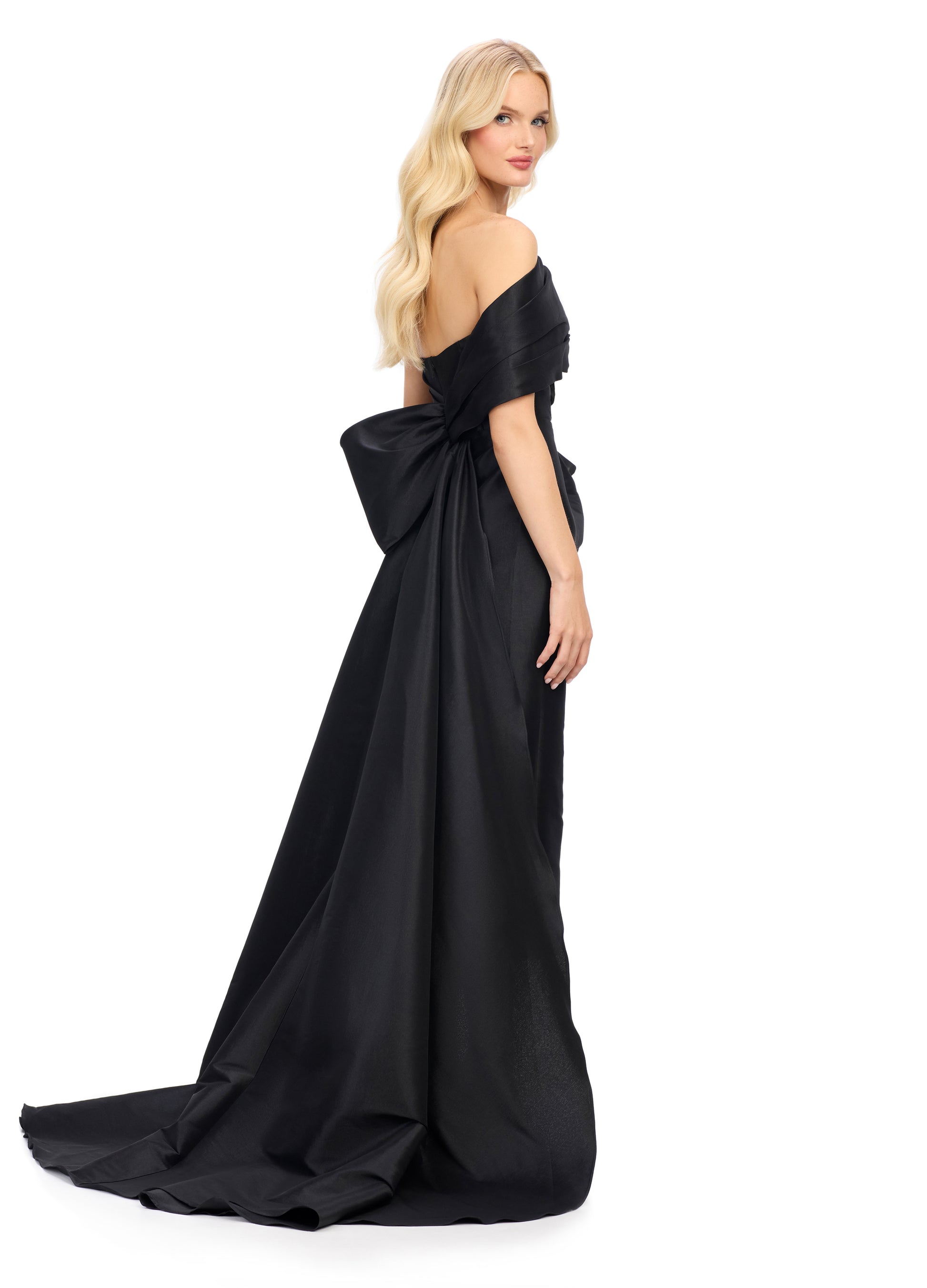 This Ashley Lauren 11727 one shoulder evening gown is a stunning choice for your next special event. The wide wrap strap and sheath design create a flattering silhouette, while the half bow in the back adds a touch of elegance. The overskirt with train adds drama and movement to the dress. Expertly designed for a sophisticated and memorable look.