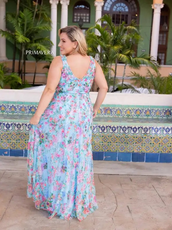 Elevate your style with the Primavera Couture 14046 Long Prom Dress. This stunning plus size gown features a beautiful floral print and elegant beaded detailing along the V-neckline. Perfect for any formal occasion, this dress is sure to make you stand out and feel confident.