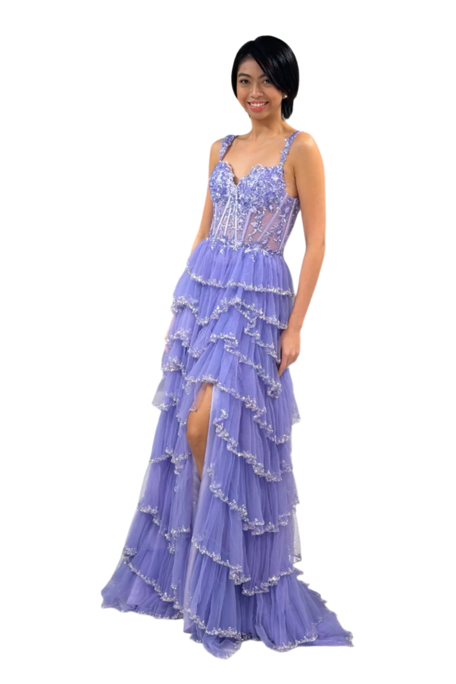 As a stunning prom dress, the Lucci Lu 1432 features intricate beaded detailing, a layered skirt design, and a lace corset top with sheer accents. The maxi length and thigh-high slit add elegance and allure, making it a perfect gown for formal events and beauty pageants.

Sizes: 0-20

Colors: Dusty Lilac, Sage Sky Blue