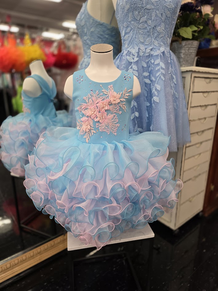 Marc Defang 5117K size 8 Turquoise girls cupcake pageant dress with pink applique on the top with crystal scattered throughout.&nbsp; Multi blue and pink ruffle skirt.

Size 8