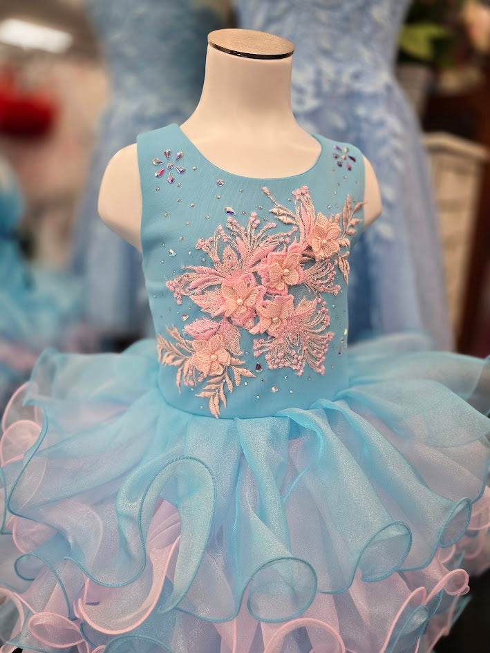 Marc Defang 5117K size 8 Turquoise girls cupcake pageant dress with pink applique on the top with crystal scattered throughout.&nbsp; Multi blue and pink ruffle skirt.

Size 8