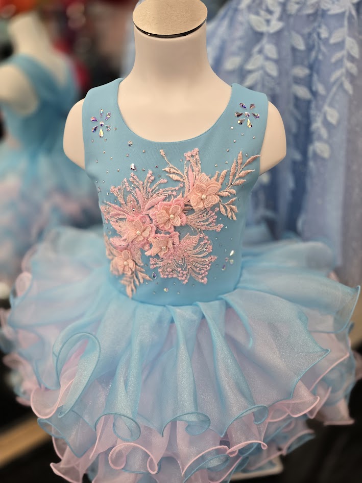 Marc Defang 5117K size 8 Turquoise girls cupcake pageant dress with pink applique on the top with crystal scattered throughout.&nbsp; Multi blue and pink ruffle skirt.

Size 8