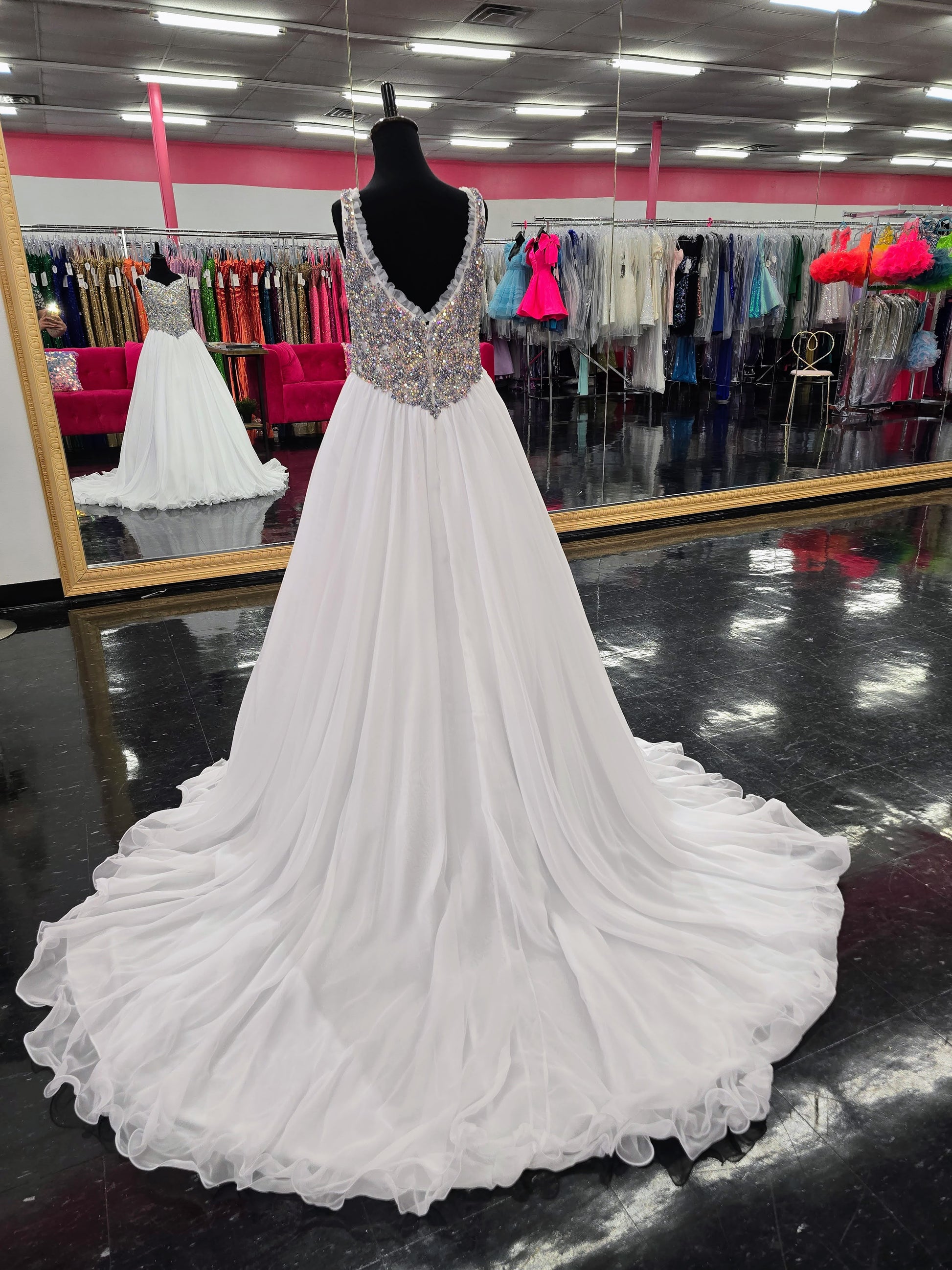 Experience the luxurious elegance of the Samantha Blake 1127 Pageant Dress. Made with soft, lightweight chiffon, this A-line ballgown will have your little girl feeling like a true princess. The crystal embellished bodice and ruffle trim neckline add a touch of sparkle and charm. Perfect for any pageant or special occasion.