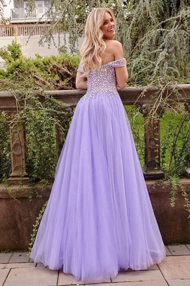 Jovani 23963 Lilac Multi Beaded Bodice Gown is a stunning and unique dress designed for events. The gown features a fully beaded bodice in a variety of colors that add a touch of sophistication to the overall look. The dress is made with tulle fabric that gives it a light and airy feel. The off-the-shoulder neckline adds a touch of glamour, while the high slit allows for ease of movement. This gown is perfect for those who want to make a statement on their special night.