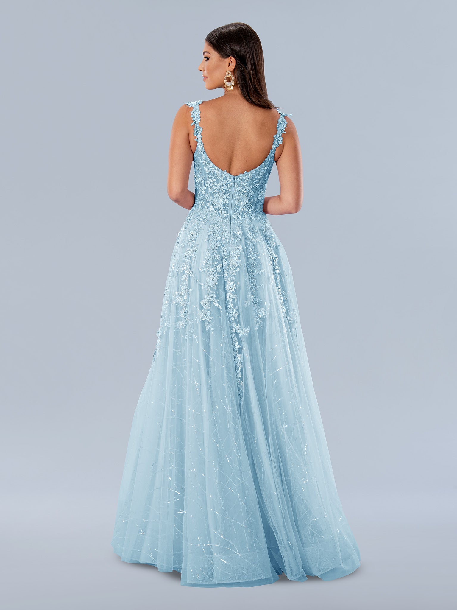 Stella Couture 24199 long A-line dress features a sheer lace corset bodice,  maxi slit, and Iridescent sequin accents. This formal gown is ideal for making a lasting impression. The timeless design is perfect for proms, weddings, and more.  Sizes: 0-24  Colors: Blue, Lilac