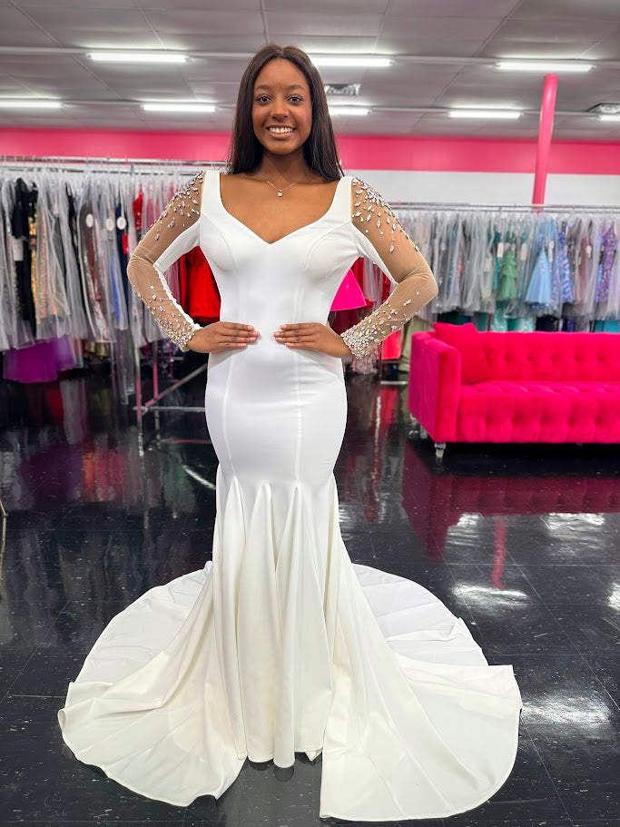 Johnathan Kayne 2441 This is a heavy knit evening gown with mesh sleeves. The hand sewn crystals add the perfect touch of glam to the shoulders and wrists, while the low back gives us a dramatic feel.

Available Colors: White

Available Sizes:&nbsp;&nbsp;8