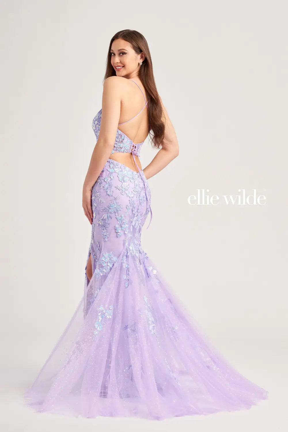 Elevate your prom look with the Ellie Wilde EW35057 dress. The sheer sequin lace corset adds a touch of elegance and the mermaid silhouette enhances your figure. With a daring slit and backless design, this dress is sure to make a statement. A scoop neck completes the look.   Sizes: 00-16  Colors: Lilac, Ice Blue