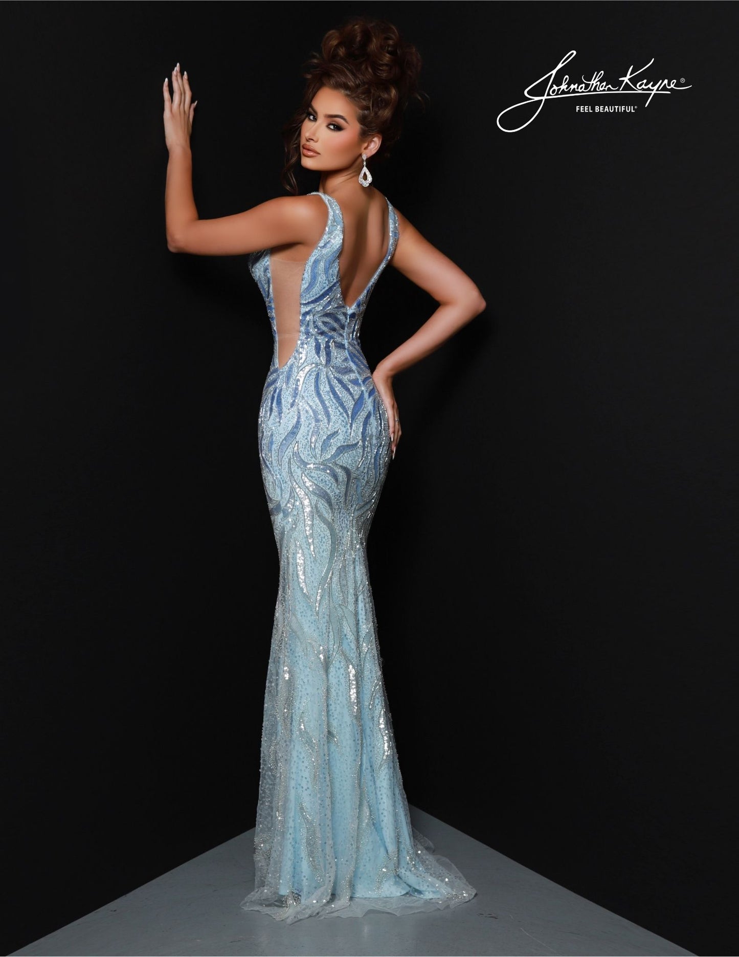 Johnathan Kayne's 2824 Long Prom Dress is perfect for a formal event. Crafted with a flattering mermaid silhouette and beaded choker cape, this elegant gown features a V-neckline, fitted waist and full-length hem. Ideal for pageants or proms. Drape yourself in luxury! This stunning gown features intricate beadwork on a mesh overlay, providing a captivating, shimmering effect. The detachable cape with choker adds a touch of drama and sophistication.