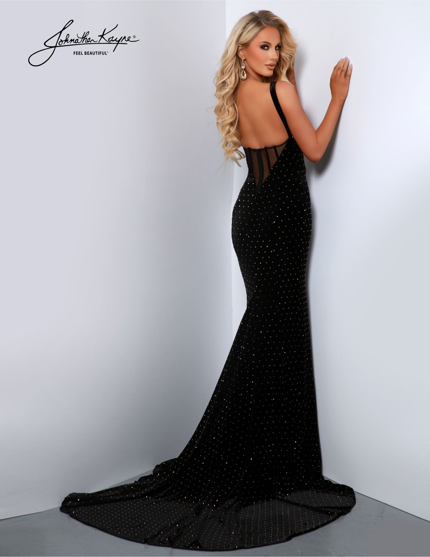 Make a dazzling entrance in this Johnathan Kayne 2871 long prom dress. Crafted from luxurious velvet, this sleek gown features a zipper front, open back, and high slit. A plunging V-neck adds to the drama, while a train accents the look. Perfect for any formal occasion. Elegance meets edginess in our stretch velvet dress, featuring a striking gold zipper and exposed boning back. The zipper is not just a functional element; it's a bold fashion statement.