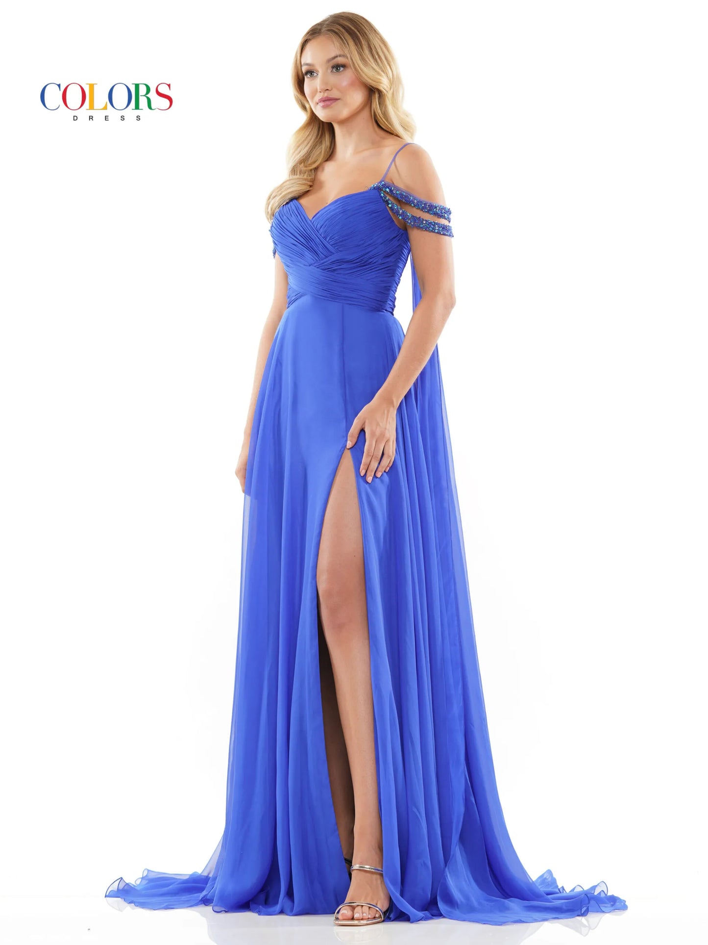 Elevate your style with the Colors Dress 3101 A Line Chiffon Pageant Dress. This stunning gown features an off the shoulder design and double beaded straps for a touch of elegance. The flowing chiffon cape adds a dramatic flair, while the maxi slit showcases your legs. Perfect for prom or any special occasion. corset back   Sizes: 0-20  Colors: Black, Royal, Deep Green, Hot Pink, Wine