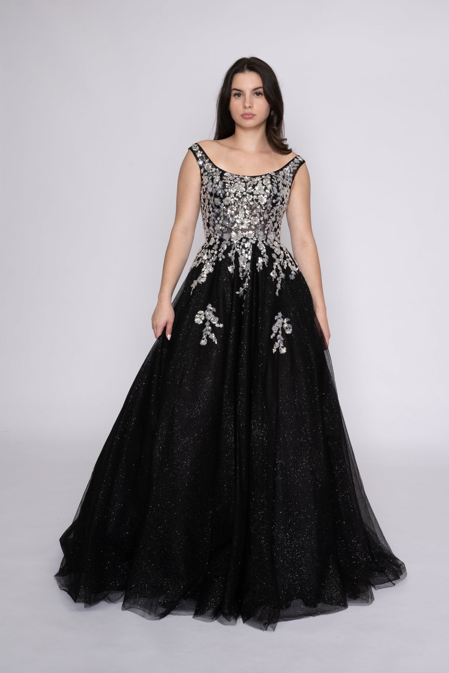 Step onto the dance floor in style with the Nina Canacci 3266 Shimmer Sequin Prom Dress. This A Line plus size ballgown features a scoop neck and shimmering sequin fabric for a glamorous look. Perfect for formal events, this dress is sure to make you stand out and feel confident all night long.

Sizes: 12-24

Colors: Fuchsia, Lilac, Black/Silver