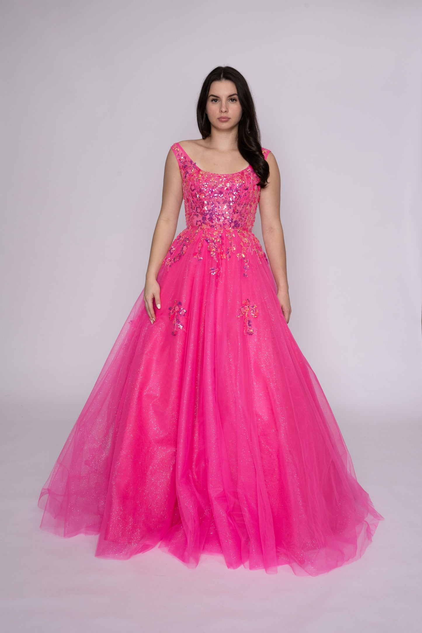 Step onto the dance floor in style with the Nina Canacci 3266 Shimmer Sequin Prom Dress. This A Line plus size ballgown features a scoop neck and shimmering sequin fabric for a glamorous look. Perfect for formal events, this dress is sure to make you stand out and feel confident all night long.

Sizes: 12-24

Colors: Fuchsia, Lilac, Black/Silver