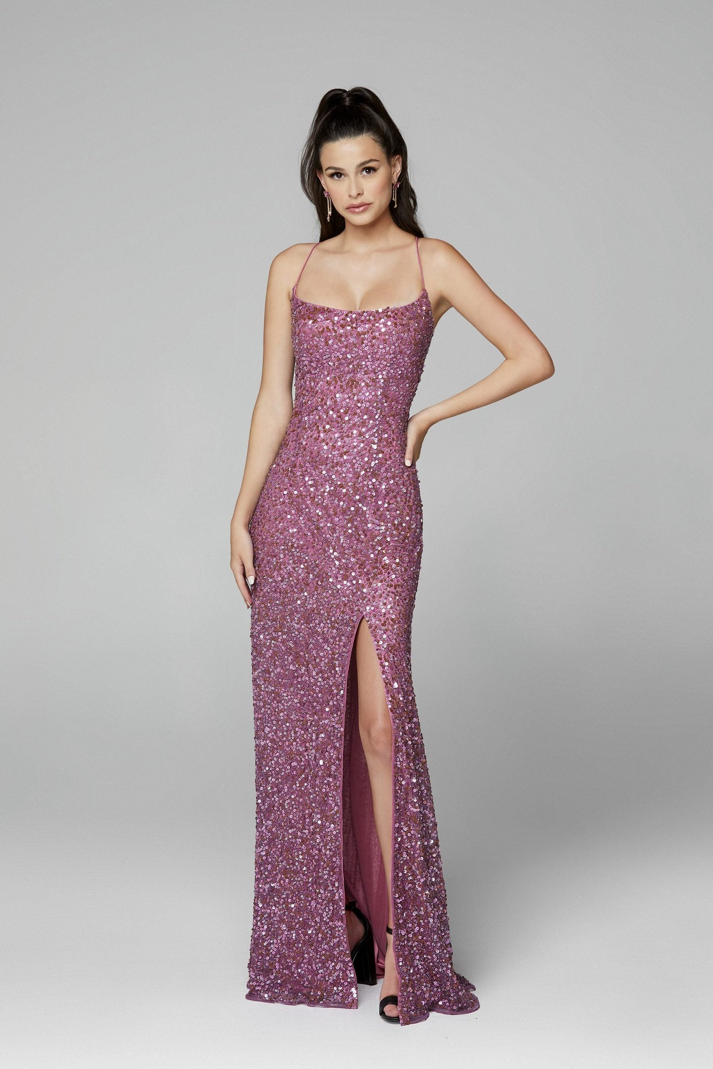 Primavera Couture 3290 This prom dress adds a pop to the multi sequins dress.  With a scoop neckline and spaghetti straps that cross and tie in the back.  This long evening dress has a side slit.