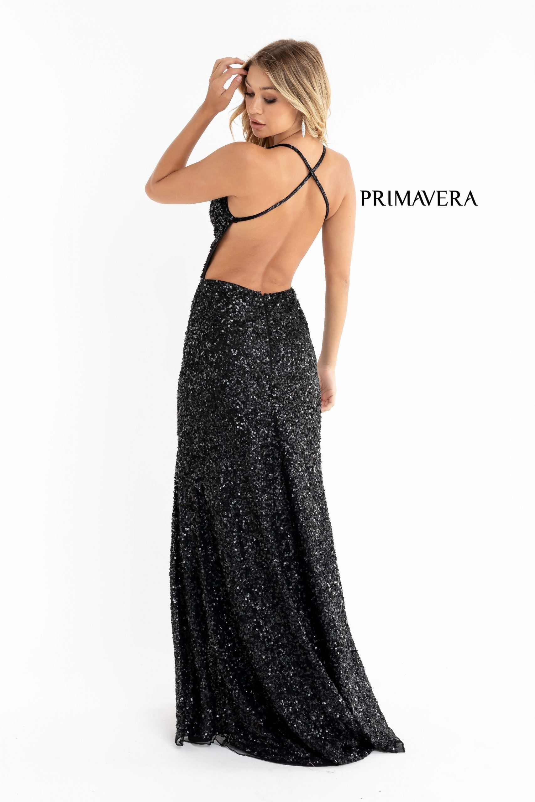 Primavera Couture 3291 Exclusive Prom Dresses.  This long prom dress is embellished throughout with shimmering sequins.  This impressive gown showcases a v neckline, thin beaded straps and crisscrossed straps in the open back. The long slim skirt has a sultry high side front slit. 