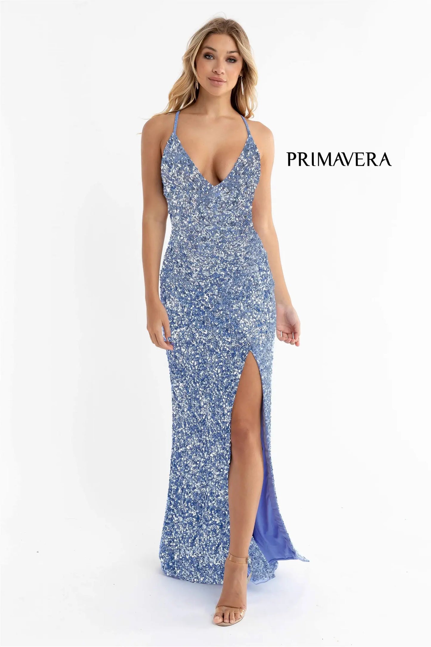 Primavera Couture 3291 Exclusive Prom Dresses.  This long prom dress is embellished throughout with shimmering sequins.  This impressive gown showcases a v neckline, thin beaded straps and crisscrossed straps in the open back. The long slim skirt has a sultry high side front slit. 