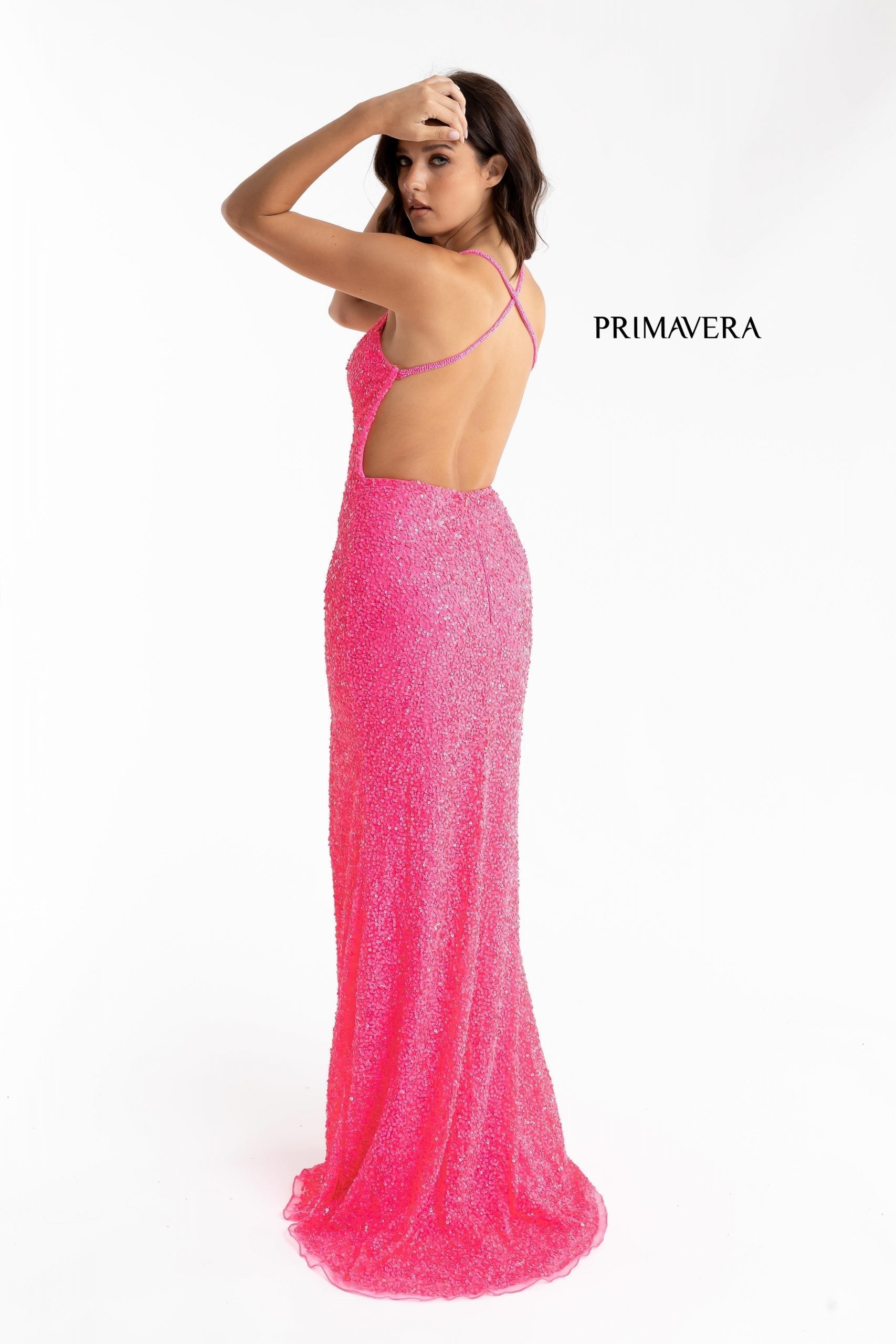 Primavera Couture 3291 Exclusive Prom Dresses.  This long prom dress is embellished throughout with shimmering sequins.  This impressive gown showcases a v neckline, thin beaded straps and crisscrossed straps in the open back. The long slim skirt has a sultry high side front slit. 