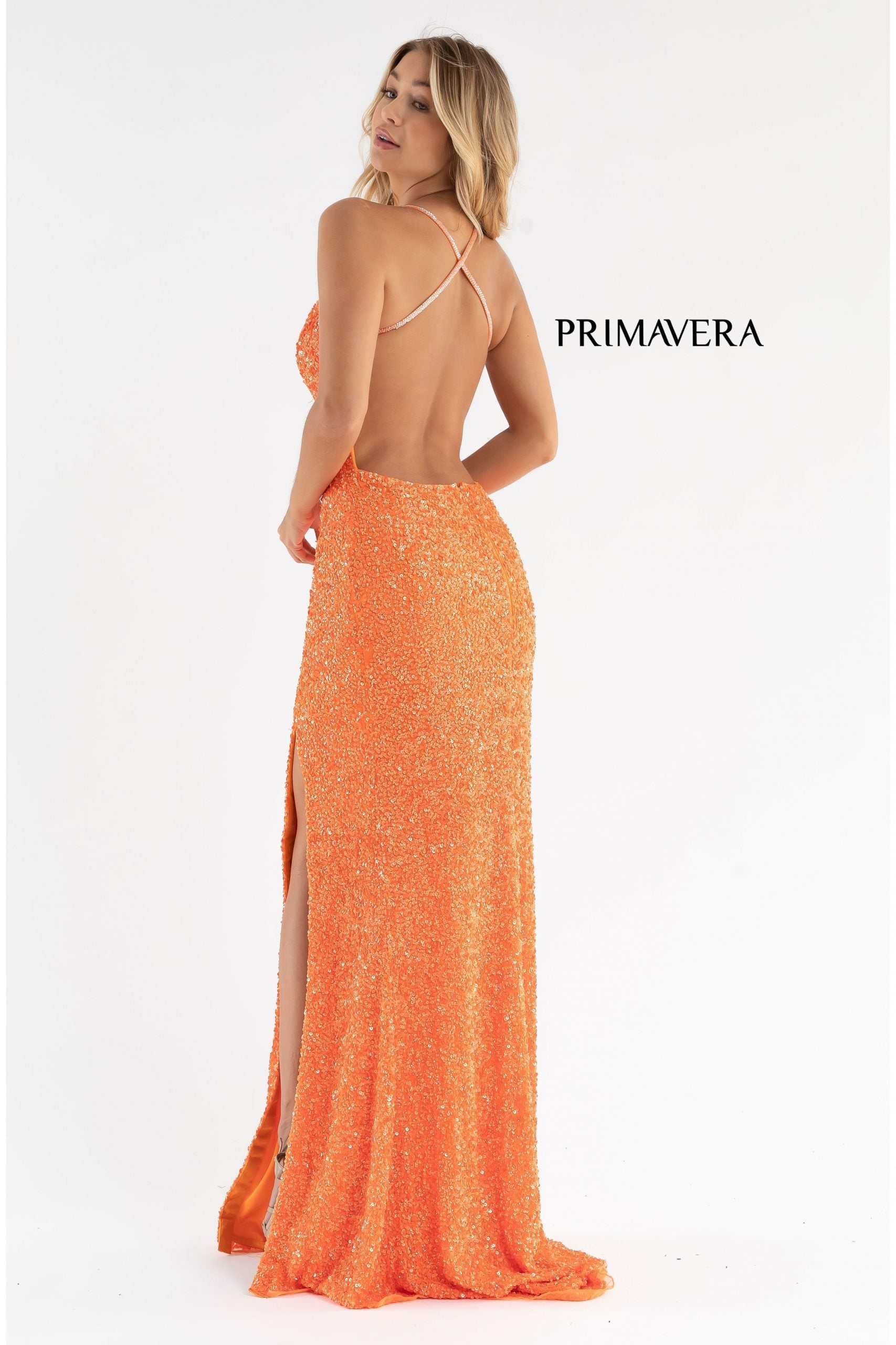 Primavera Couture 3291 Exclusive Prom Dresses.  This long prom dress is embellished throughout with shimmering sequins.  This impressive gown showcases a v neckline, thin beaded straps and crisscrossed straps in the open back. The long slim skirt has a sultry high side front slit. 