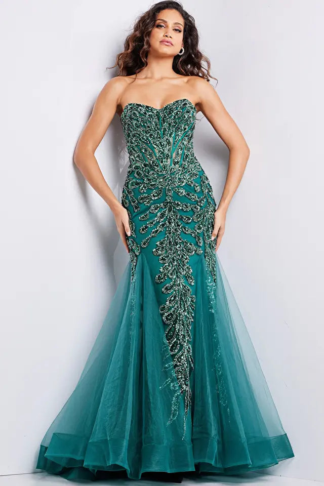 The Jovani 37142 is a captivating formal and prom dress designed to make a bold and glamorous statement. It is crafted from lightweight and delicate tulle fabric, known for its graceful drape and ethereal quality.  This gown features a mermaid silhouette, renowned for its dramatic, figure-hugging design that flares out at the bottom, adding an elegant and alluring touch to the overall look.