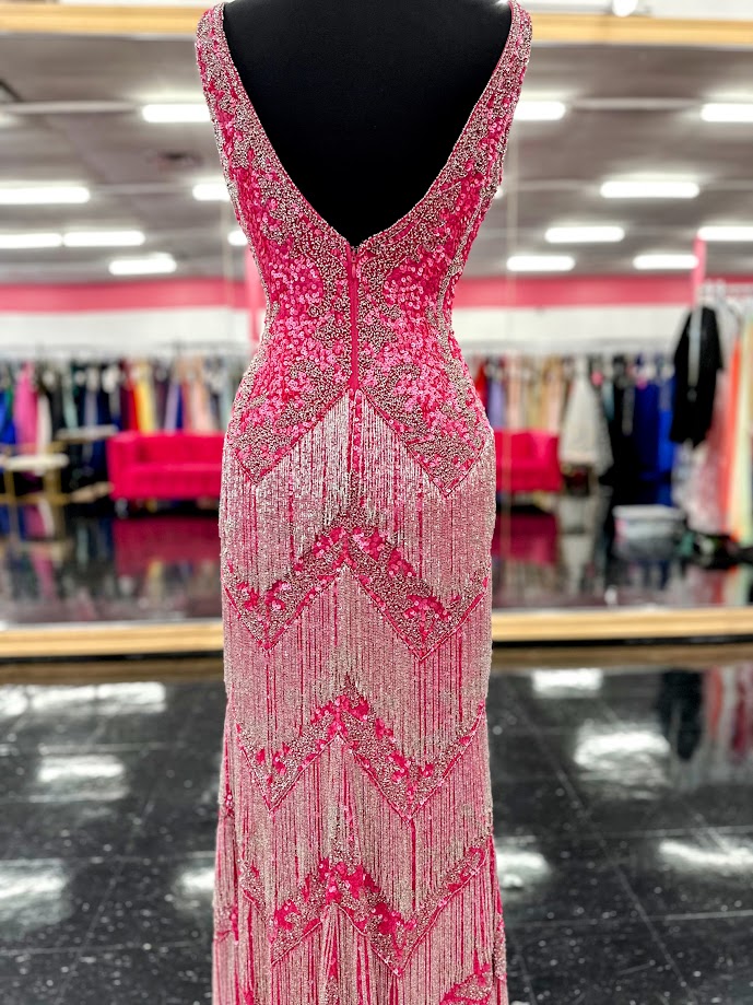 The Jovani 38847 Prom Dress is a stunning gown that exudes elegance and glamour. Made with exquisite sequin beading and delicate fringe details, this dress will make you feel like a star on any special occasion. Featuring a sexy slit and a flattering V-neckline, it's the perfect choice for proms, pageants, and formal events. Look and feel your best with this one-of-a-kind dress.