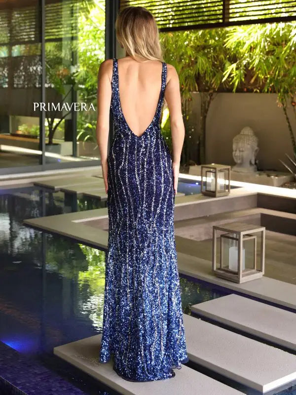 Elevate your formal event with the Primavera Couture 4103 Long Prom Dress. With its fitted silhouette and high slit, this sequin gown is designed to flatter your figure and catch the eye. The V-neck and open V-back add a touch of elegance, making it the perfect choice for a pageant or prom.